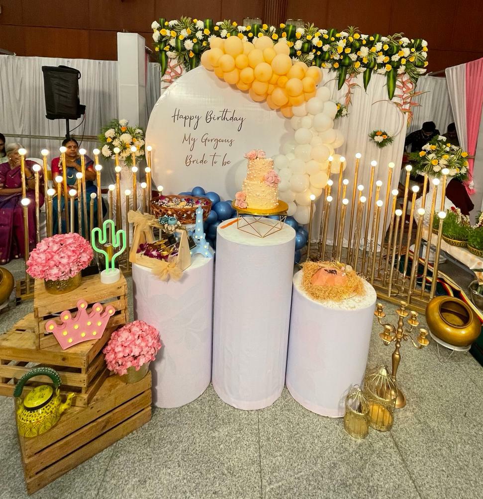 Desert Bloom Cake Table — Pastel plinths, candles and cactus florals around a layered birthday cake.
