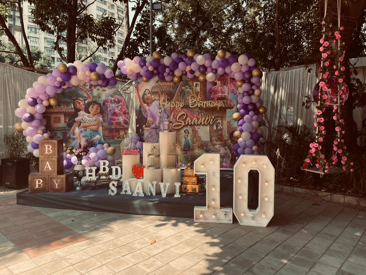 Lilac Ten — An outdoor lilac balloon arch with marquee numbers for a tenth birthday.