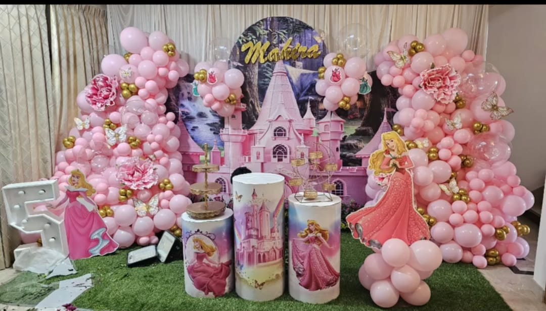 Princess Castle — A fairytale castle backdrop with rose balloon clusters for a little girl's day.