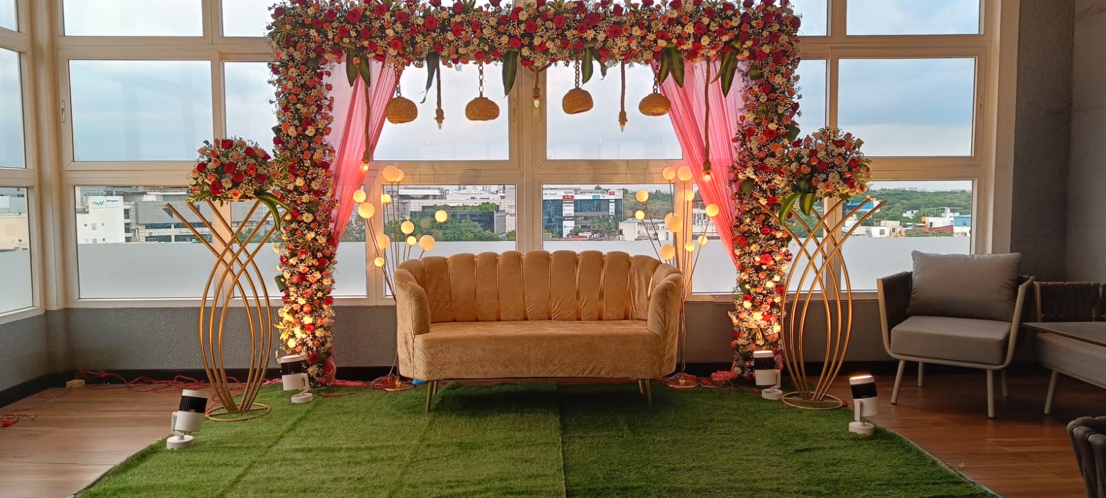 The Maroon Canopy — A draped canopy mandap in deep maroon with warm floral strings.