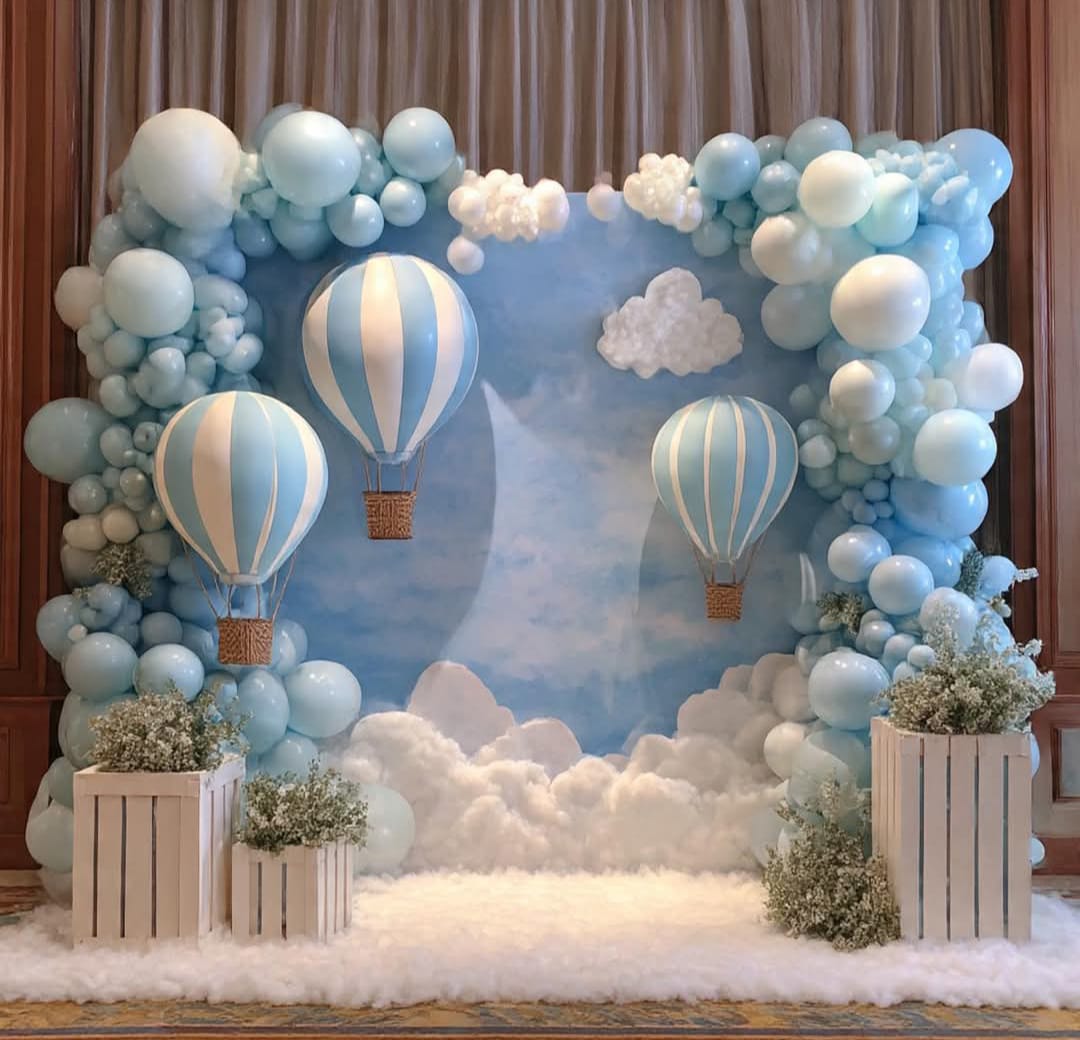 Up, Up & Away — Hot-air balloons and sky-blue clouds for a first birthday dreamscape.